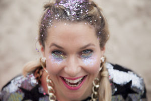 Girl with Glitter Makeup and Glitter Roots Looking at Camera
